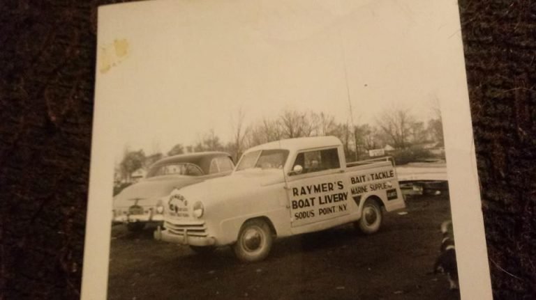 Snapshot of a pickup truck lettered 'Raymer's Boat Livery, Sodus Point NY, Bait & Tackle, Marine Supplies'