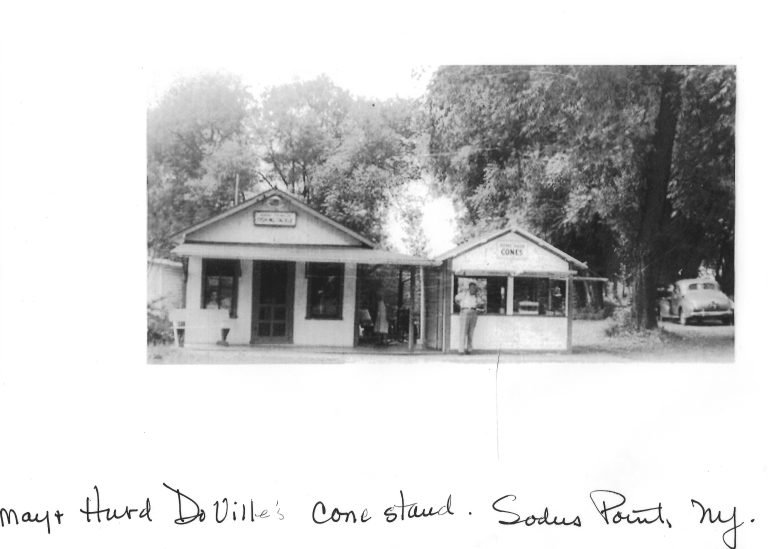 Small white roadside stands under trees, one signed 'Cones', handwritten 'May & Hurd DeVille's cone stand'
