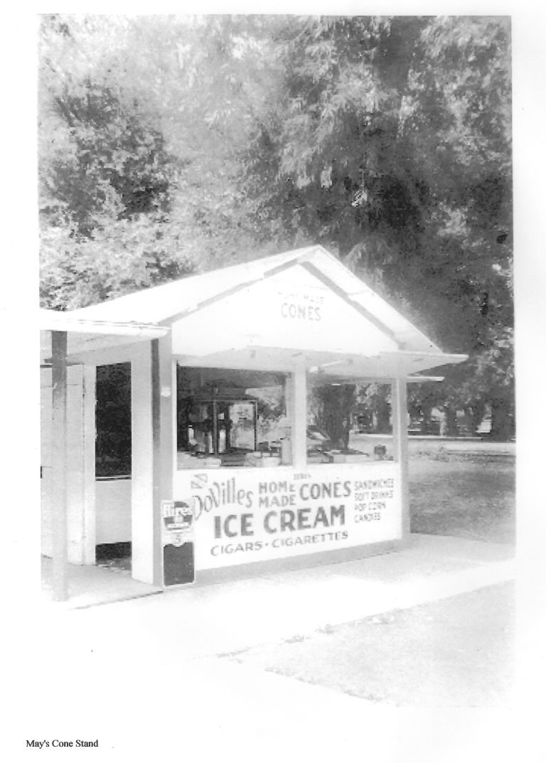 May's Cone Stand, a small stand with signs for DoVille's homemade cones and ice cream, under trees