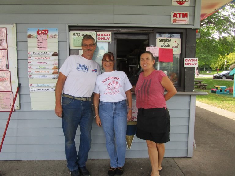 Gary Grey, Robin Sofia and Kelly Grey standing together in front of the Hots Point ice cream stand window