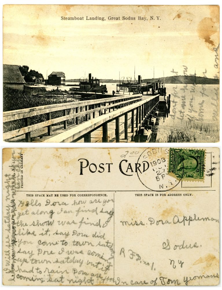Postcard front and back: 'Steamboat Landing, Great Sodus Bay, N.Y.', a walkway to docked steamers, plus a written note