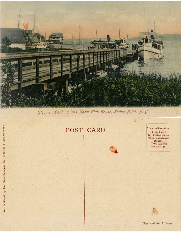 Hand-colored postcard of a wooden pier, steamers and the Yacht Club house at Sodus Point, with its blank back