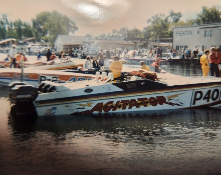 Racing powerboat 'Agitator', numbered P40, tied at a crowded dock with other race boats